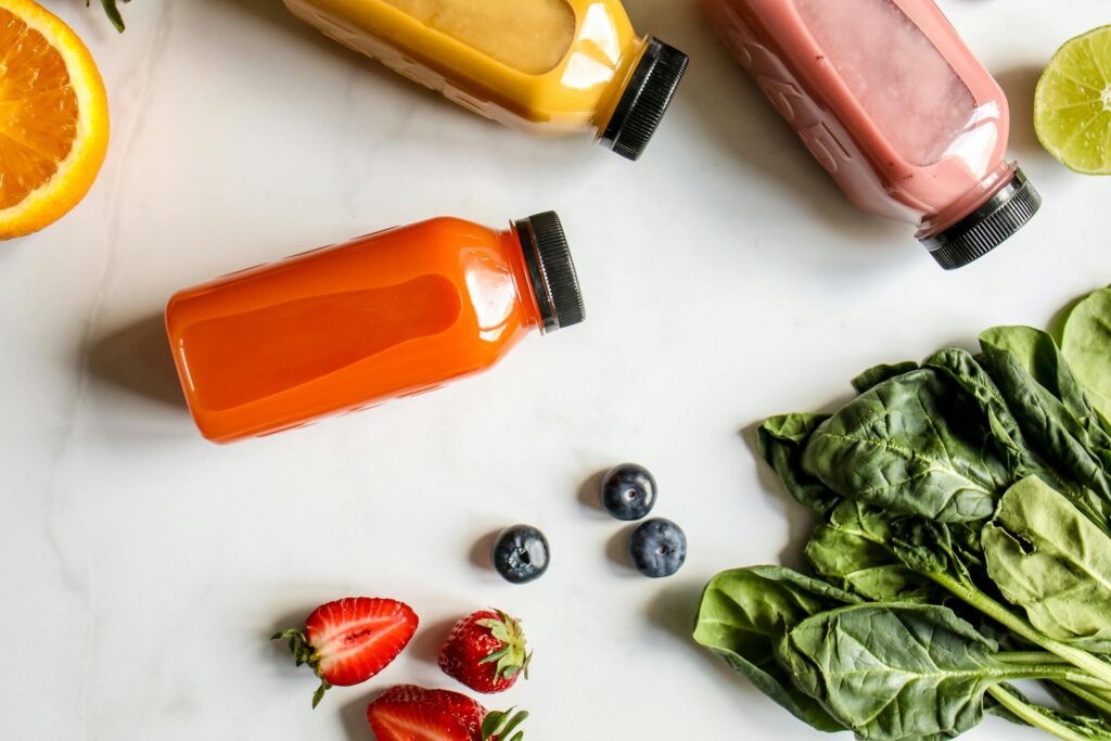 Top view of colorful juices and fresh ingredients for a healthy diet.