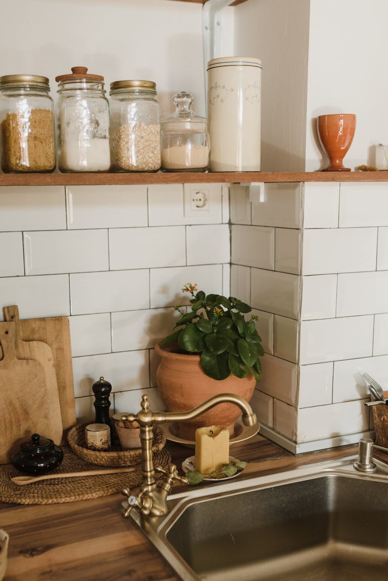 A cozy rustic kitchen setup with a brass faucet and decorative elements.