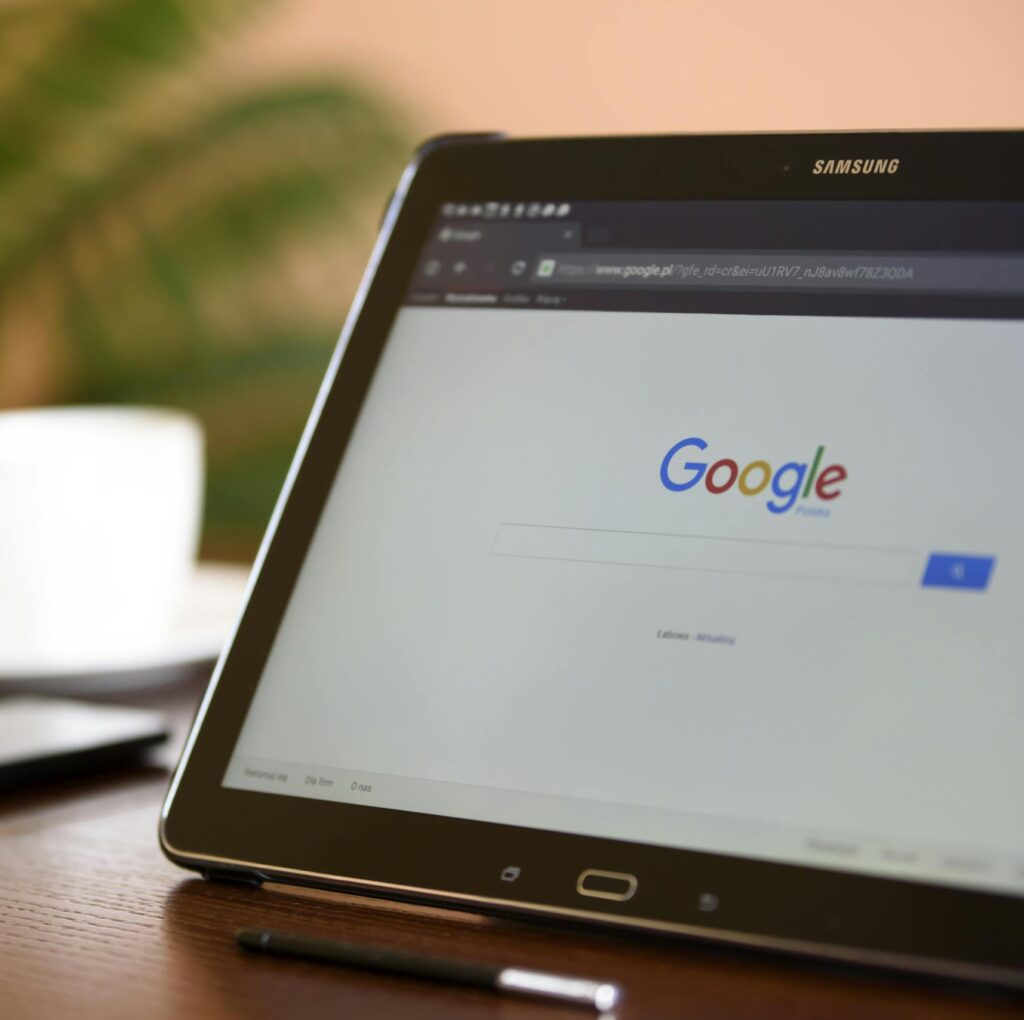 Samsung tablet on desk showing Google homepage, perfect for technology-related content.