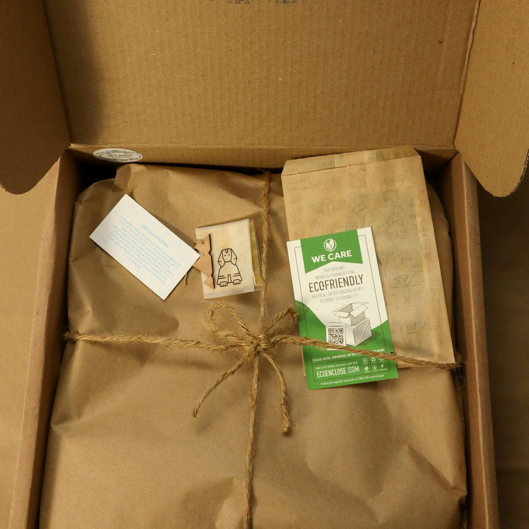 Sustainable packaging with eco-friendly materials inside an open cardboard box.