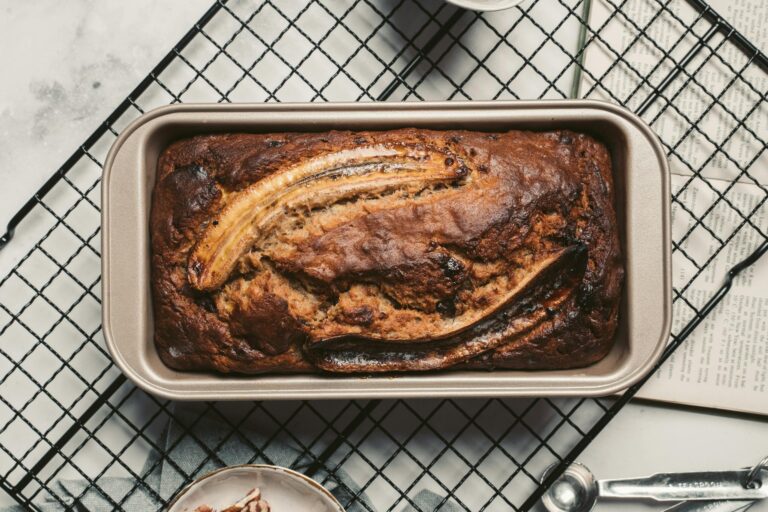 Top view of a delicious homemade banana bread fresh from the oven placed on a cooling rack. Enjoy the warm and inviting aroma.