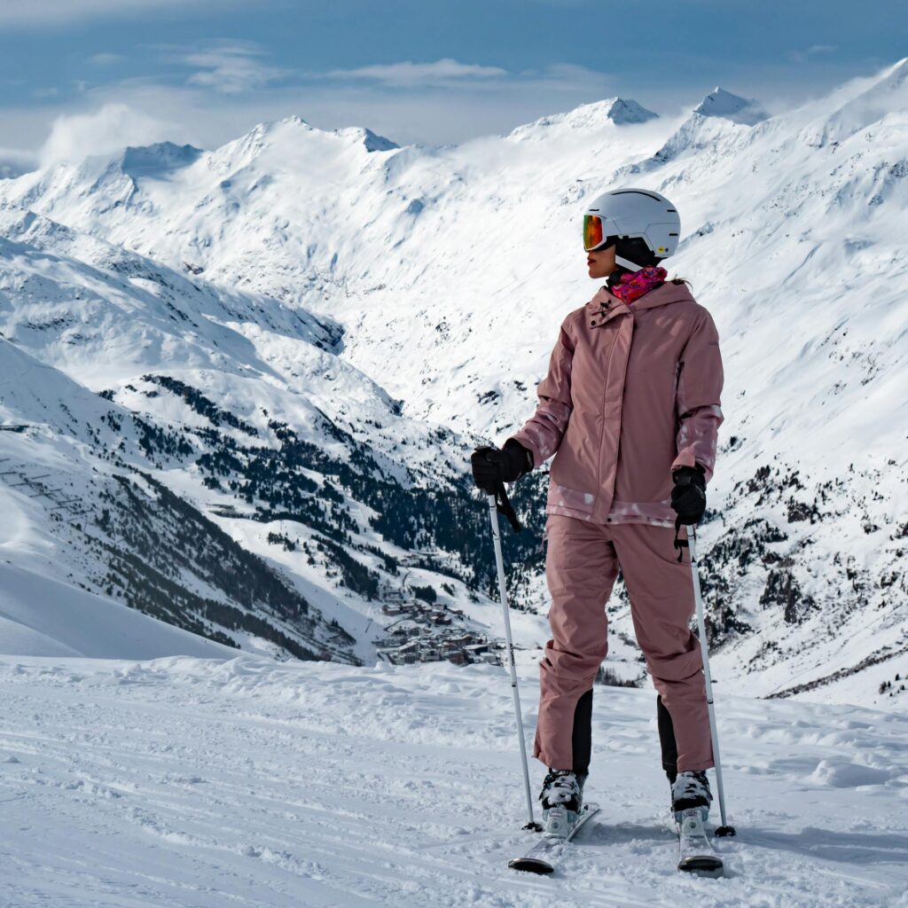 A skier enjoys the snowy mountain views in Gurgl, Tirol in winter.