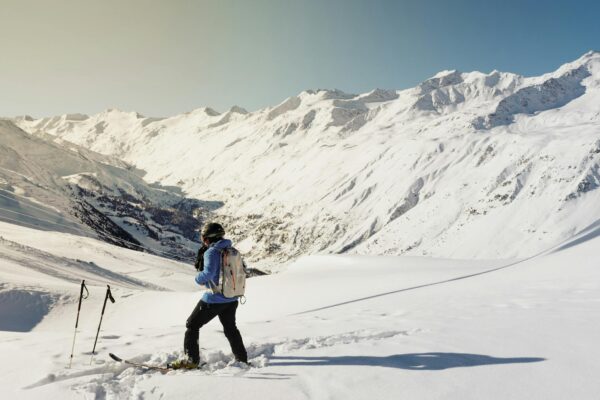 A skier enjoying a sunny day on snow-covered slopes in Gurgl, Austria.