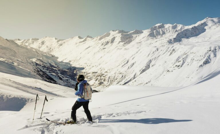 A skier enjoying a sunny day on snow-covered slopes in Gurgl, Austria.