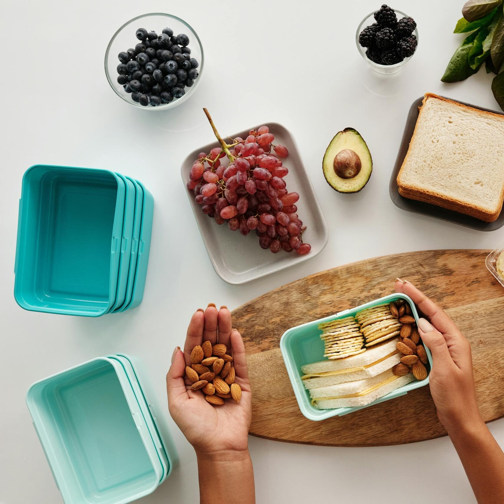A vibrant flat lay of preparing a healthy snack with fresh ingredients like fruits, nuts, and cheese.