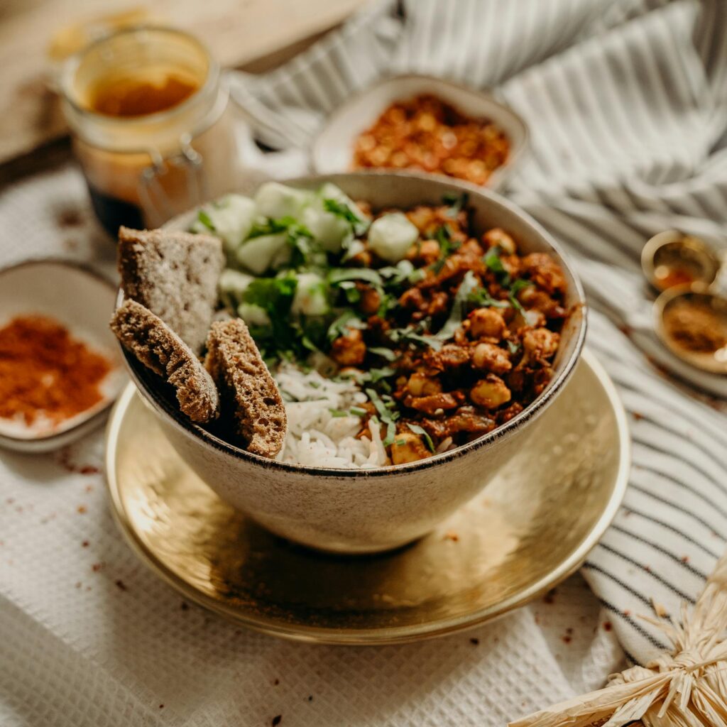 A delicious, healthy vegan bowl featuring chickpeas, rice, cucumbers, and spices. Perfect for a nutritious meal.